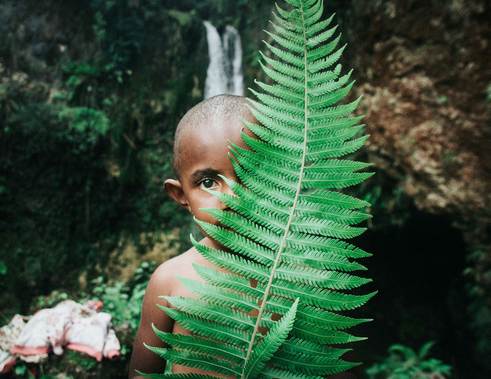 Tribe-girl-behind-leaf