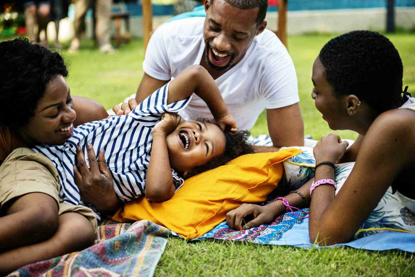 Dark-skin-family-member-lying-on-the-grass-laughing